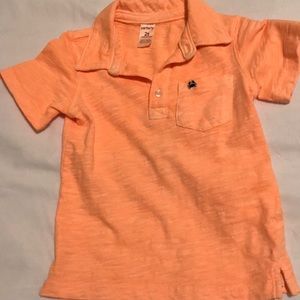 Carter’s orange polo with crab emblem
